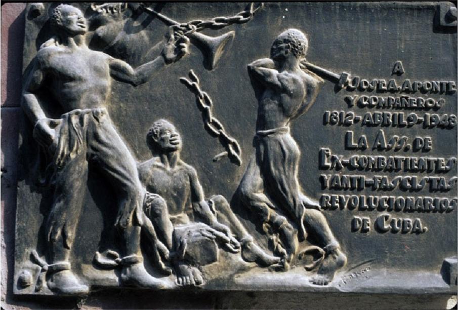 bronze bas-relief monument to Jose Aponte; the image is of an Afro-Cuban man striking the chains off two other enslaved men
