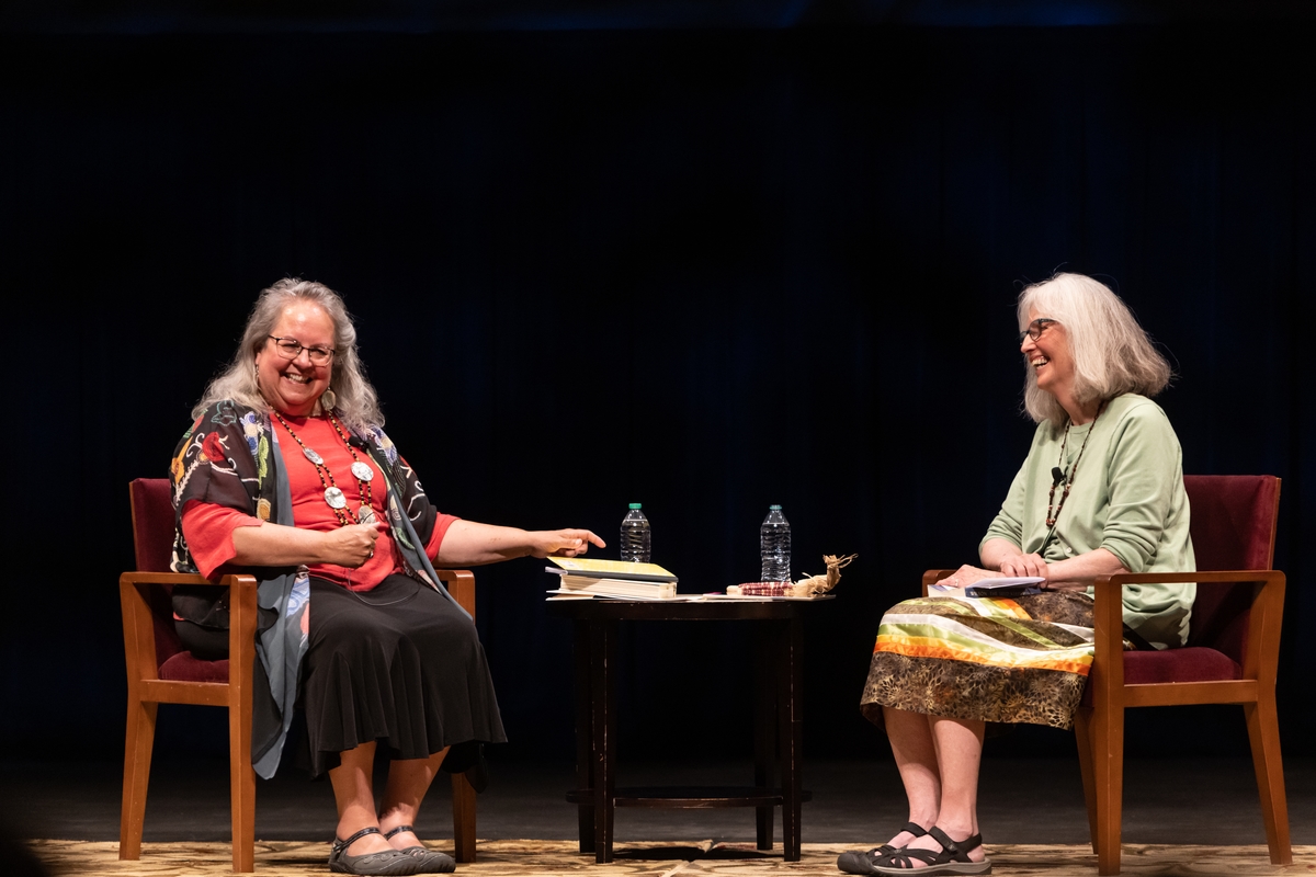 Two Indigenous women on stage in conversation